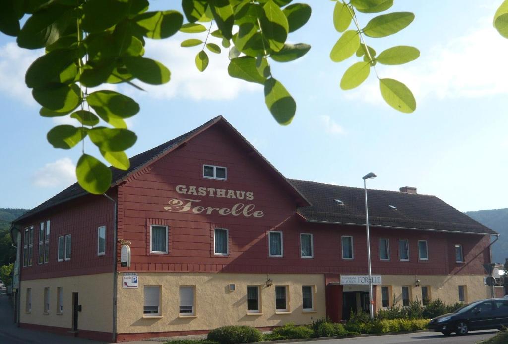 un edificio rojo con las palabras hotel de Navidad en él en Gasthaus Forelle, en Thale