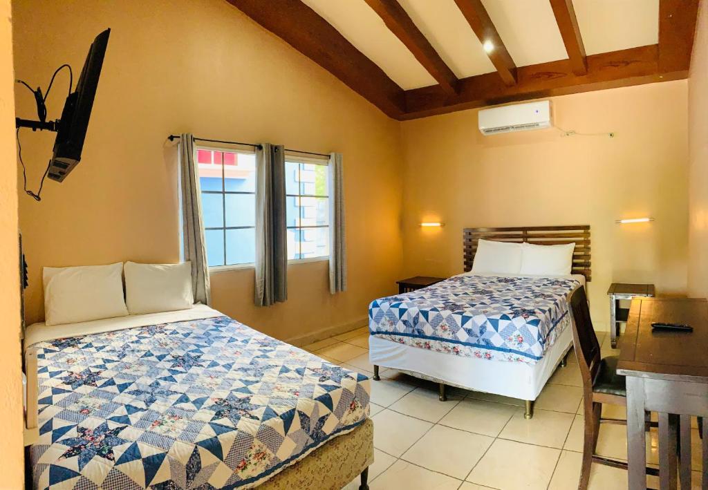 Postel nebo postele na pokoji v ubytování Hotel El Encanto