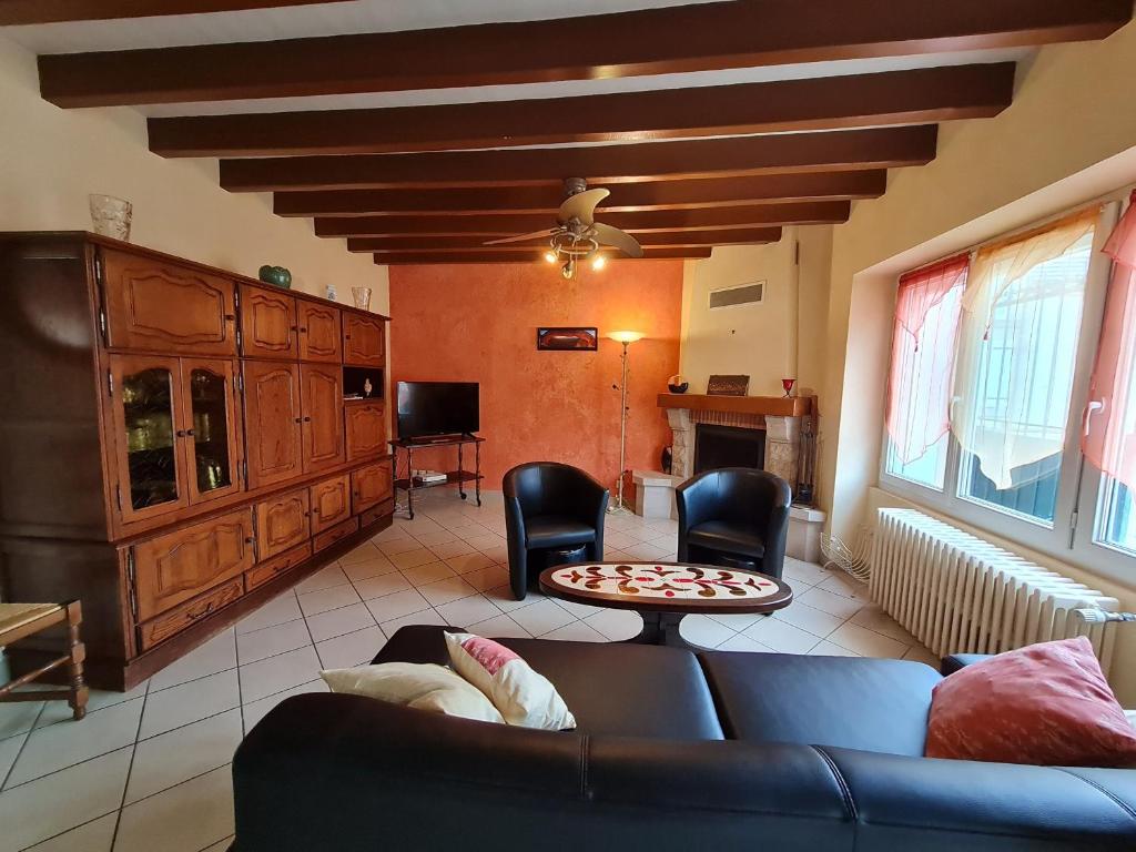 a living room with a couch and a table at Grande maison rénovée près d'Orléans et Chambord - Idéale pour familles et amis - FR-1-590-12 in Cléry-Saint-André