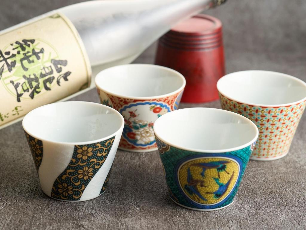 a group of four cups sitting on a table at Hotel Resol Trinity Kanazawa in Kanazawa