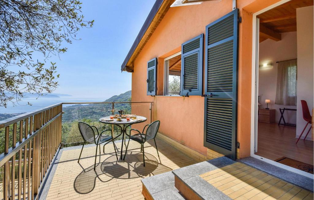 a patio with a table and chairs on a balcony at La Casetta Tra Cielo E Mare in San Lorenzo della Costa
