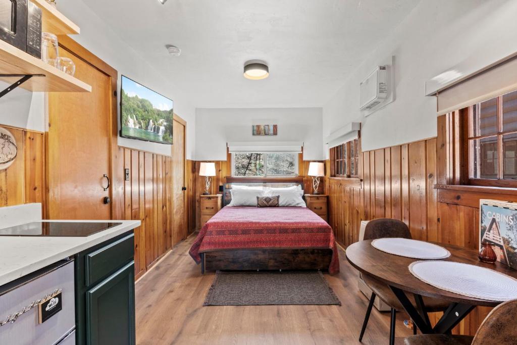 a bedroom with a bed and a table and chairs at Timber Lodge #7 in Colorado Springs