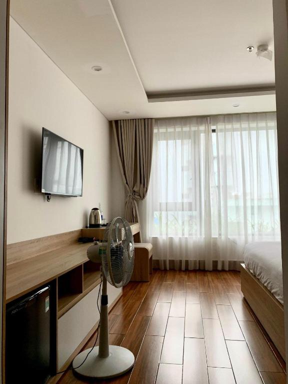 TV a/nebo společenská místnost v ubytování Rice's House Hotel & Apartment