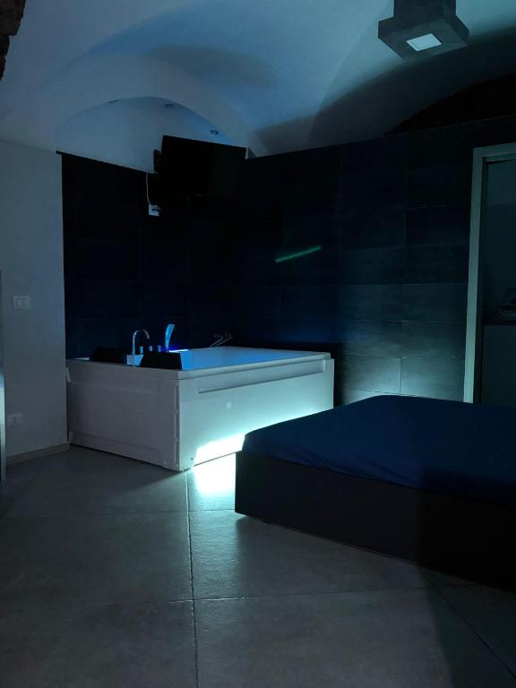 a dark room with a sink and a bed at HomeSuite45 in Catania