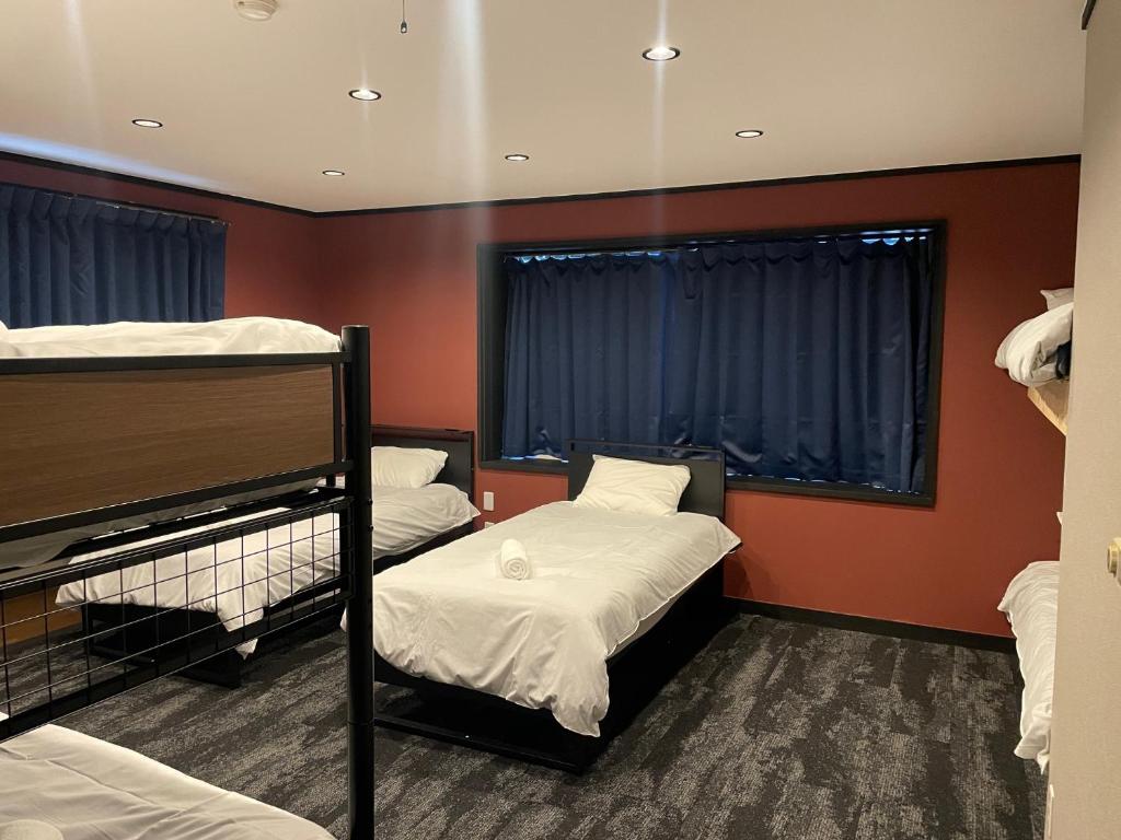 Postel nebo postele na pokoji v ubytování Ember Lodge - Hakuba