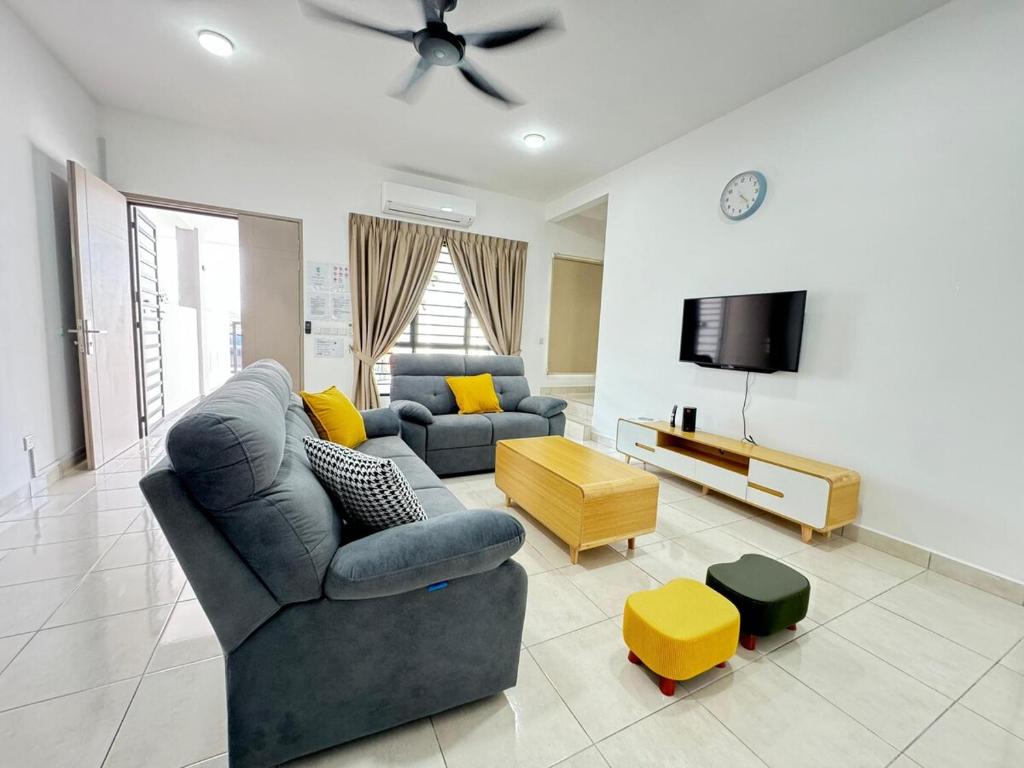 a living room with a couch and a tv at 31 RIMBUN KIARA KEPAYANG SEREMBAn in Seremban