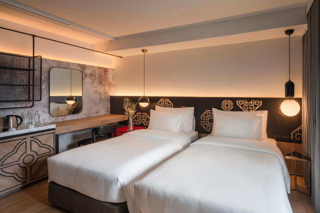 Postel nebo postele na pokoji v ubytování PASSA Hotel Bangkok