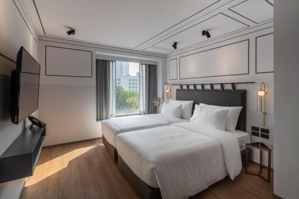 Postel nebo postele na pokoji v ubytování PASSA Hotel Bangkok