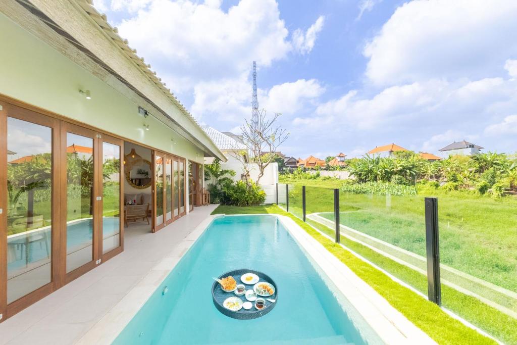 a swimming pool in the backyard of a house at Villa Maria-2BR Private Villa in Canggu in Kerobokan