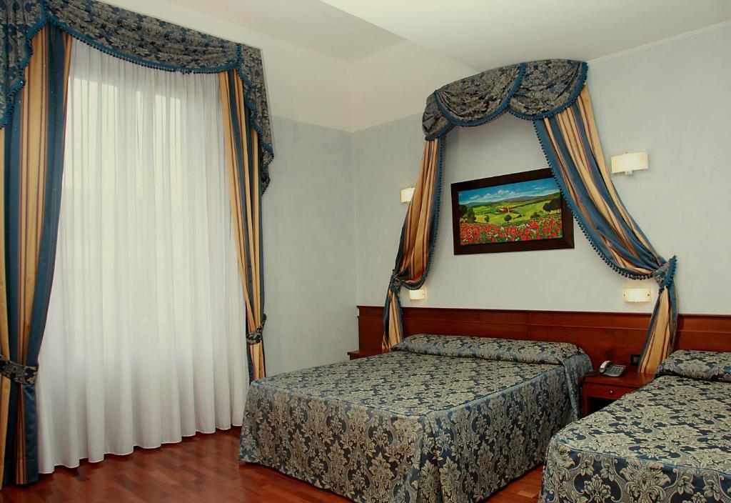 Postel nebo postele na pokoji v ubytování Hotel Palazzo Vecchio