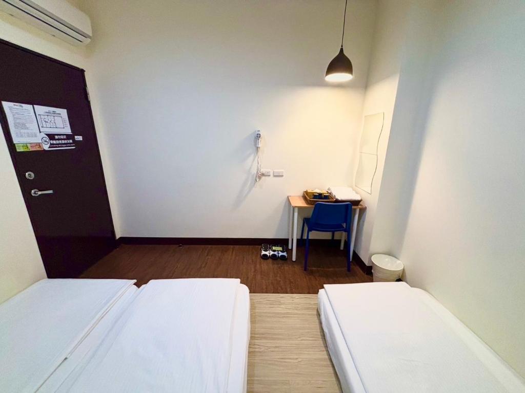 Postel nebo postele na pokoji v ubytování Douzi Hotel-Xpark. Gloria Outlets. Taoyuan MRT