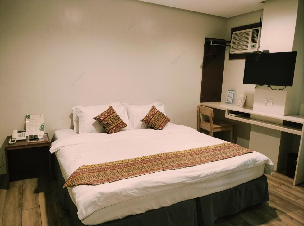 Postel nebo postele na pokoji v ubytování The Lanang Suites