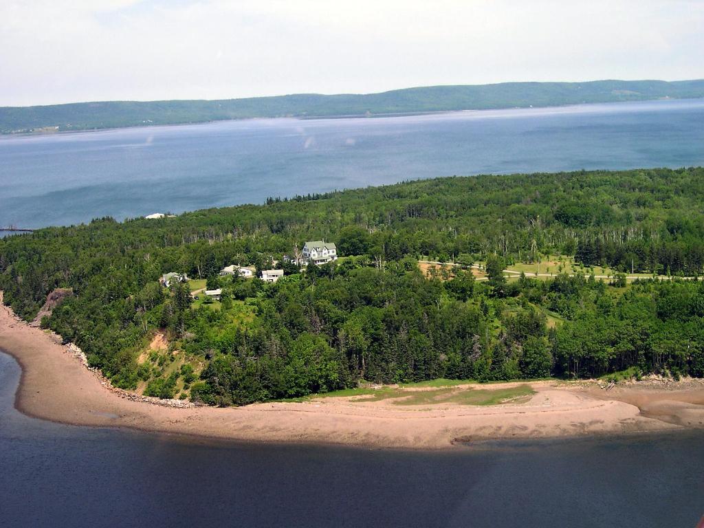 an aerial view of a house on an island in the water at Still Point Lodge in Deep Brook