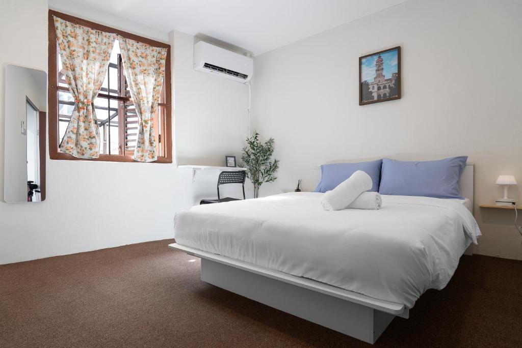 Ένα ή περισσότερα κρεβάτια σε δωμάτιο στο A Cozy Place Penang