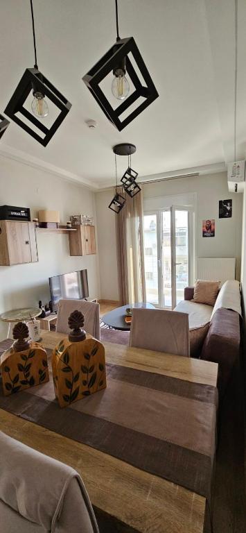 a living room with two couches and a table at SWEET & CHILLI Home 28 in Thessaloniki