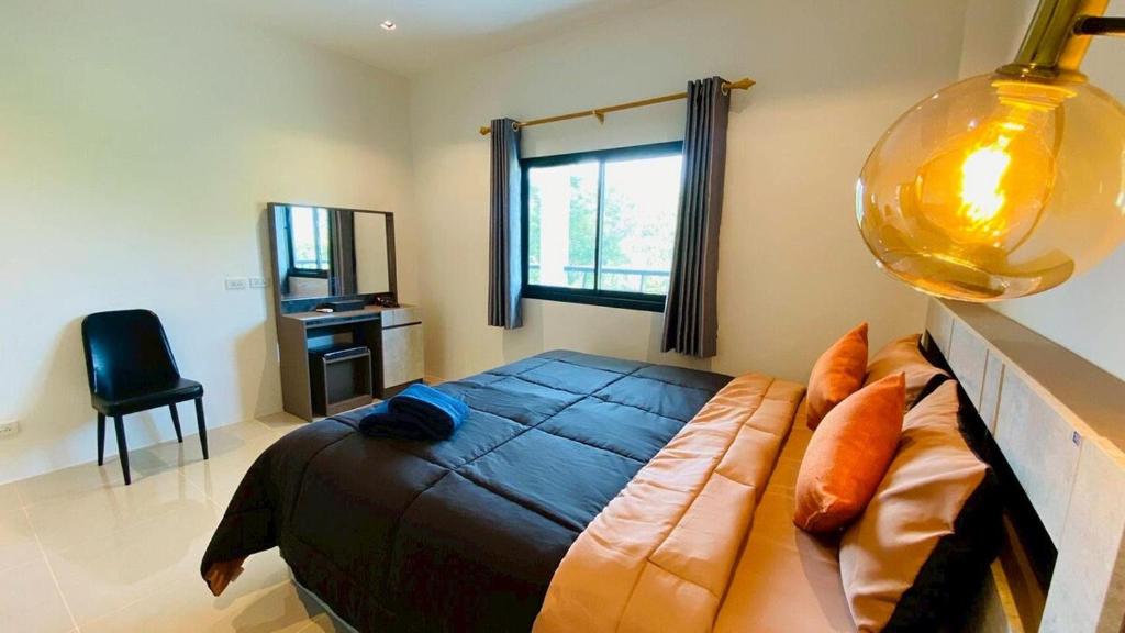 a bedroom with a large bed and a window at Private Sanctuary Yanui beach in Nai Harn Beach