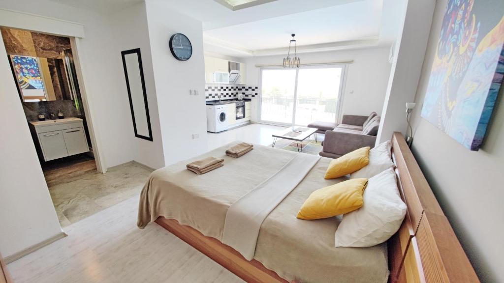 a bedroom with a large bed and a living room at Edelweiss Success Home Beach in Iskele