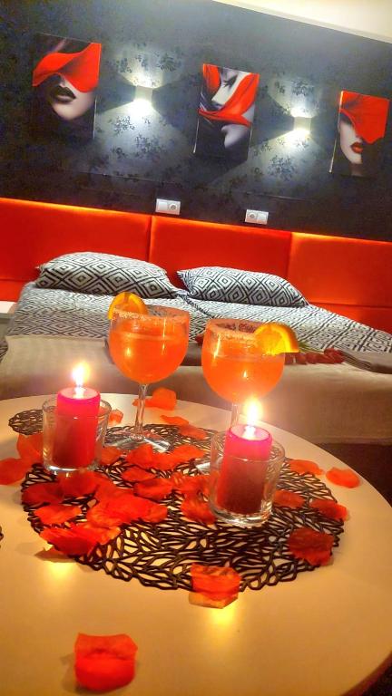 a table with two candles and two glasses on it at HORTENSJA 304 in Koszalin