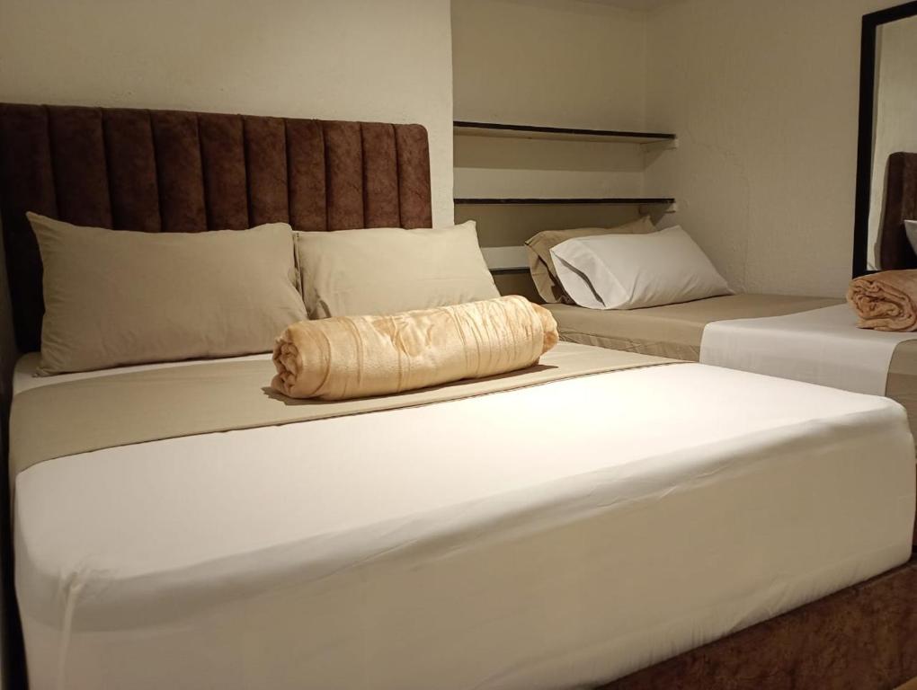 Postel nebo postele na pokoji v ubytování Hotel Aerocafe Pereira