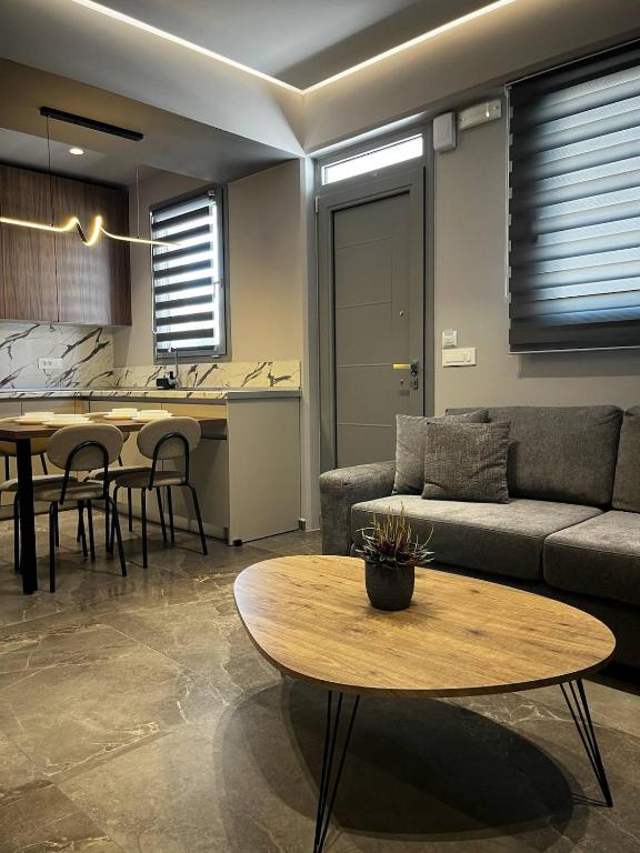 a living room with a couch and a table at Castalia Naiades Suites in Ialysos