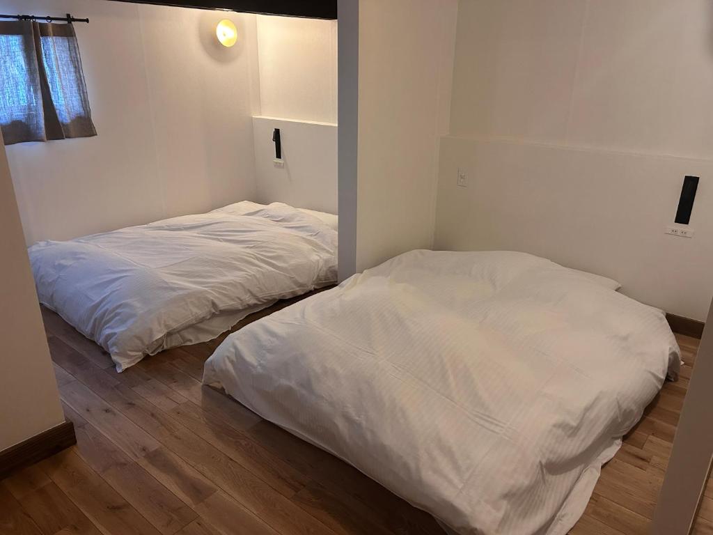 Postel nebo postele na pokoji v ubytování 囲み宿 こわね