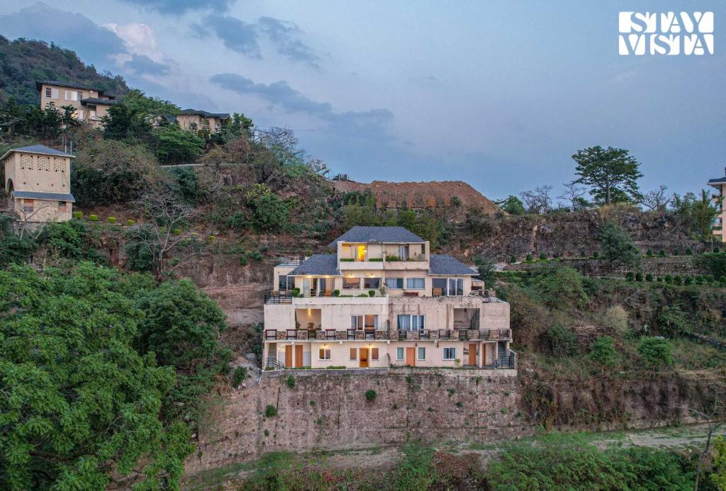 a house on the side of a mountain at StayVista at Echoes of Ease with Bonfire & WiFi in Rishīkesh
