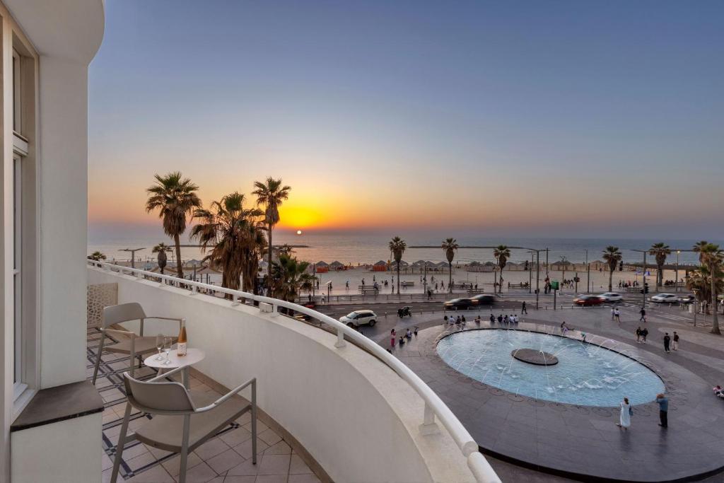a view from the balcony of a building with a pool at The Herbert Tel Aviv in Tel Aviv