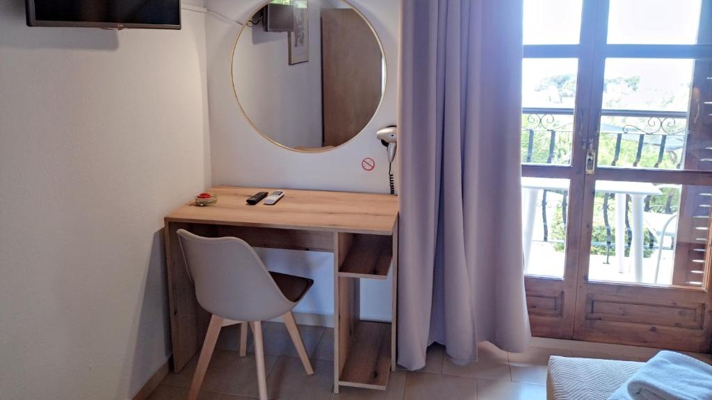 a bathroom with a vanity with a mirror and a chair at Villa Anna Maria in Agia Paraskevi