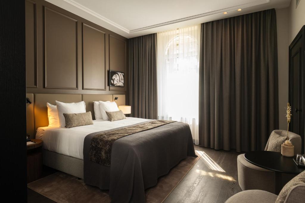 Postel nebo postele na pokoji v ubytování Boutique Hotel Beaumont Maastricht