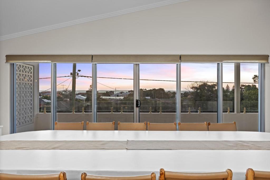 a dining room with a large table and chairs at Silver Sands Sanctuary - 6BR Beachside Luxury in Mandurah