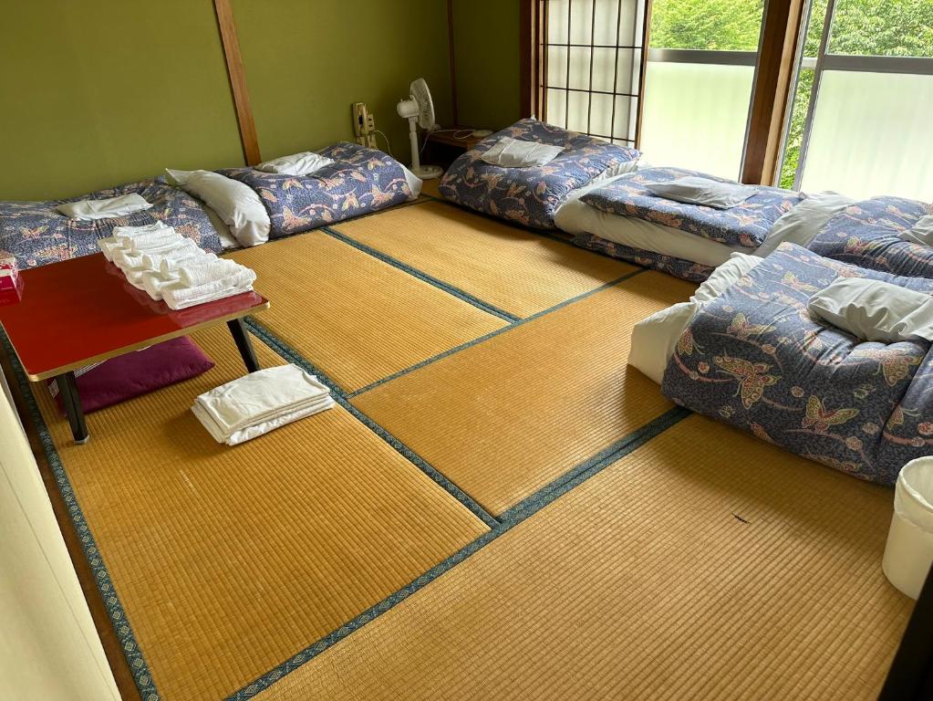 Postel nebo postele na pokoji v ubytování 苗場 中村屋