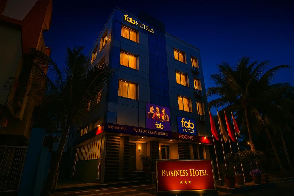 a building with a lit up sign in front of it at FabHotel Happy Homely Stay - Airport road in Pune