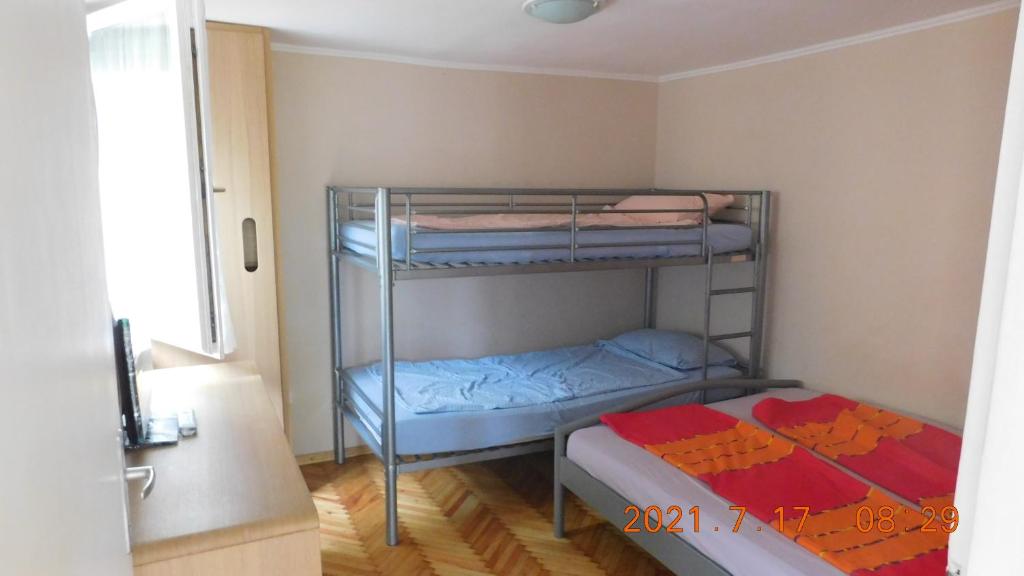 Postel nebo postele na pokoji v ubytování LiMa Apartman Ház