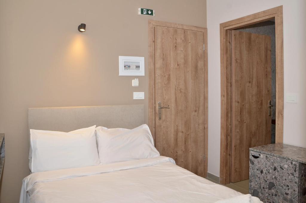 Postel nebo postele na pokoji v ubytování Centroom Suites