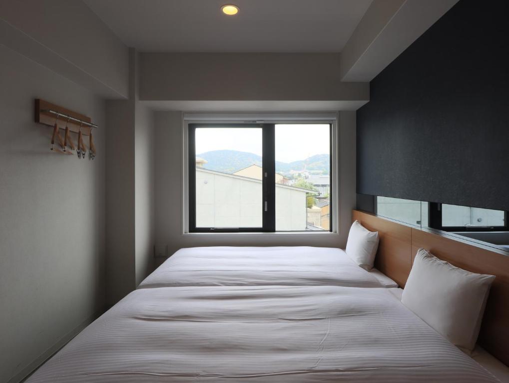 Postel nebo postele na pokoji v ubytování Hotel Glad One Kyoto Shichijo by M's