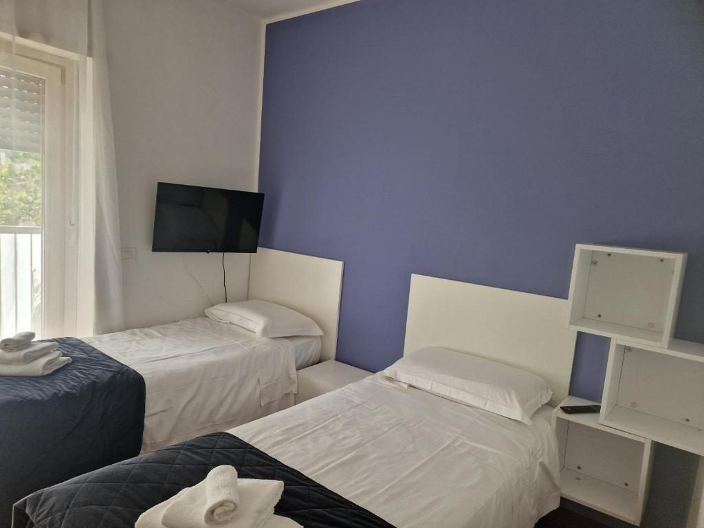 Postel nebo postele na pokoji v ubytování Asso Residence Ospedale