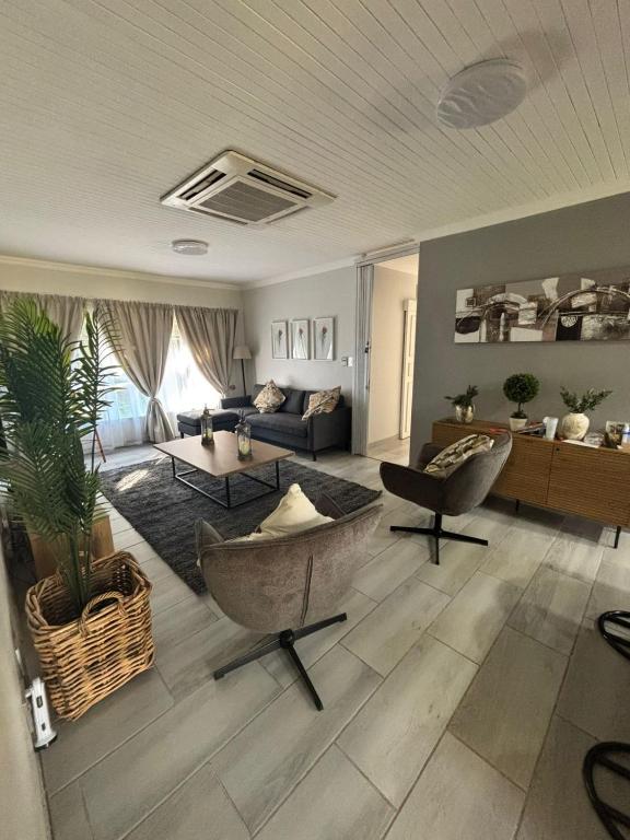a living room with a couch and a table at Shamba Self-Catering in Pretoria