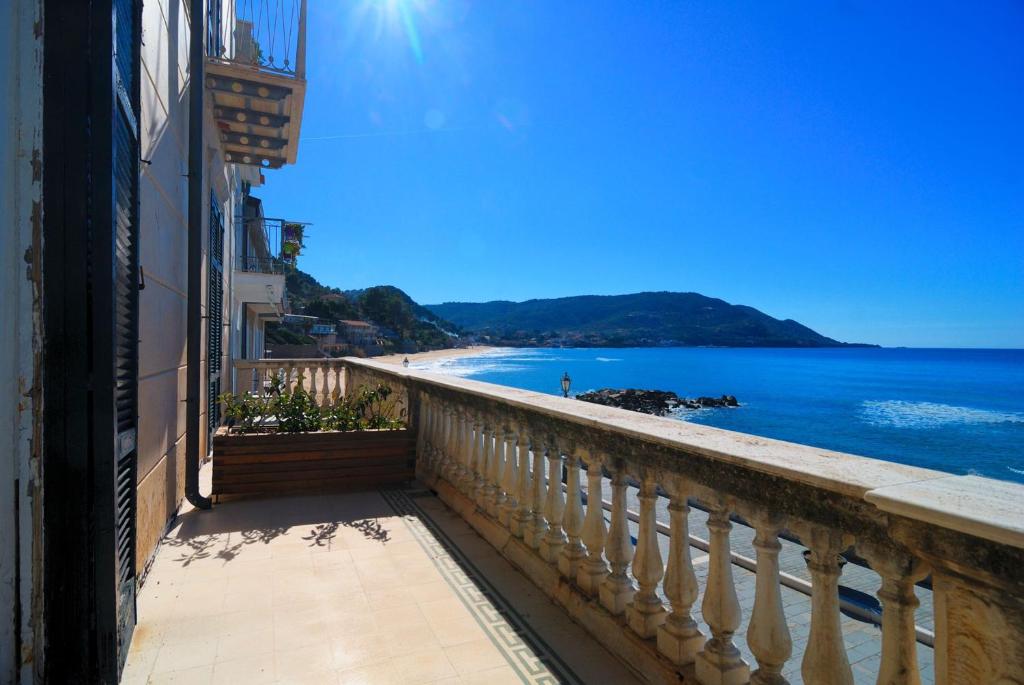 a balcony of a building with a view of the ocean at Residenza D'epoca 1861 in Santa Maria di Castellabate