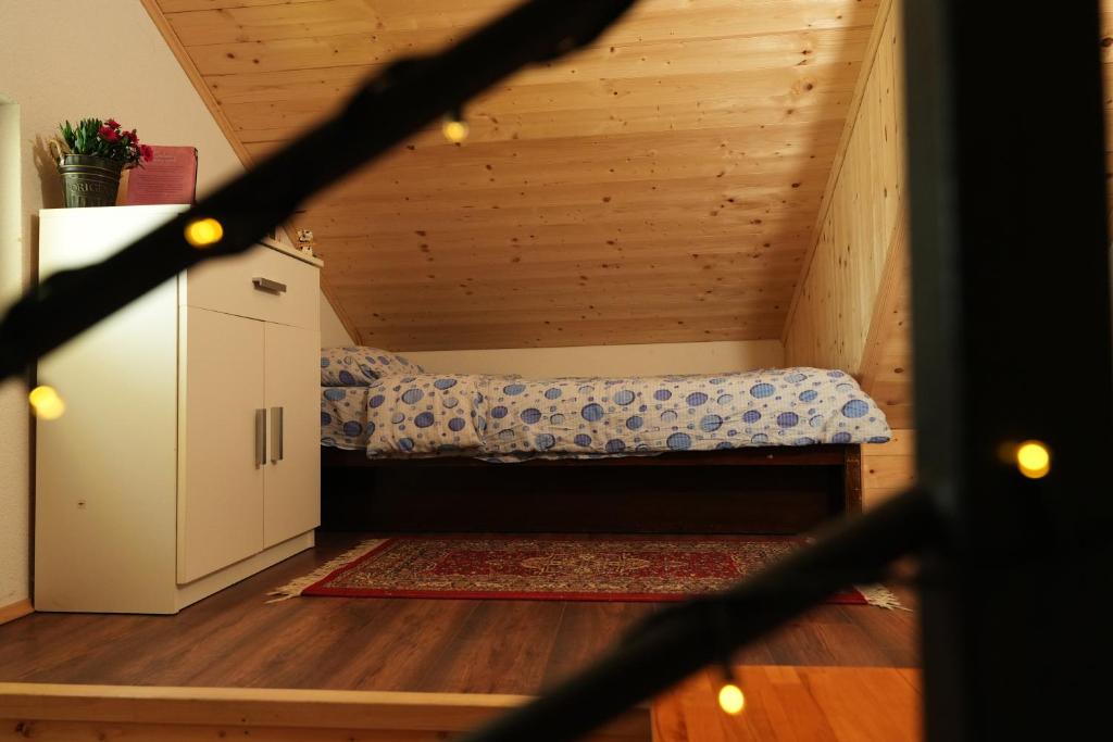a small room with a bed in the attic at Mladenović Kuća in Kopaonik