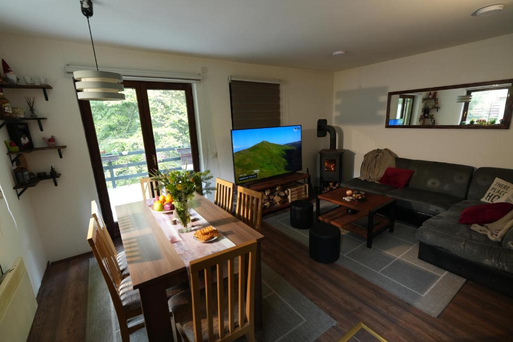 a living room with a couch and a table at Mladenović Kuća in Kopaonik