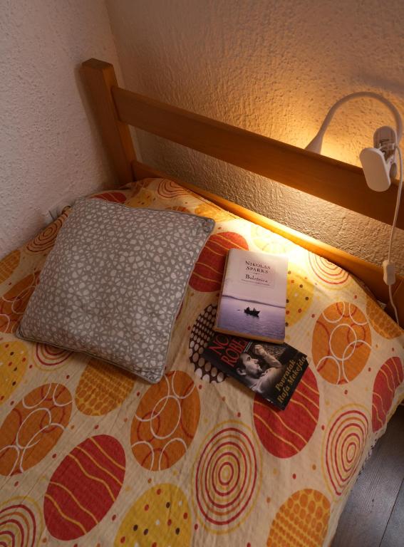 a bed with a laptop computer on top of it at Mladenović Kuća in Kopaonik