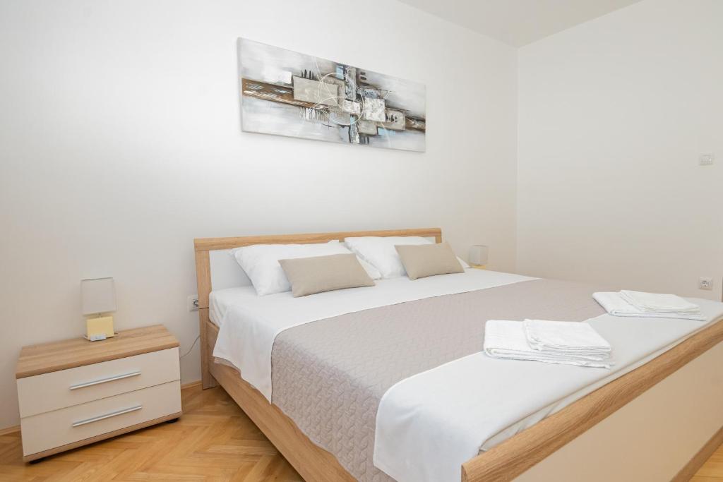 Postel nebo postele na pokoji v ubytování Apartmani Cimerman