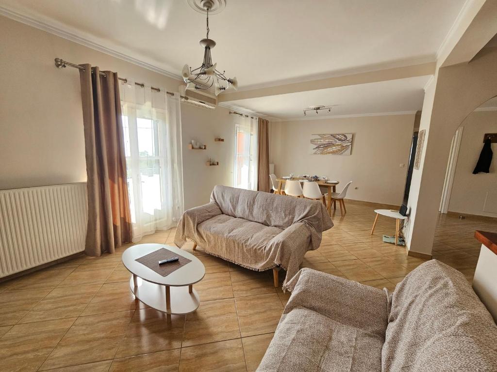 a living room with a couch and a table at Sylvia's Sweet Home in Kato Korakiana