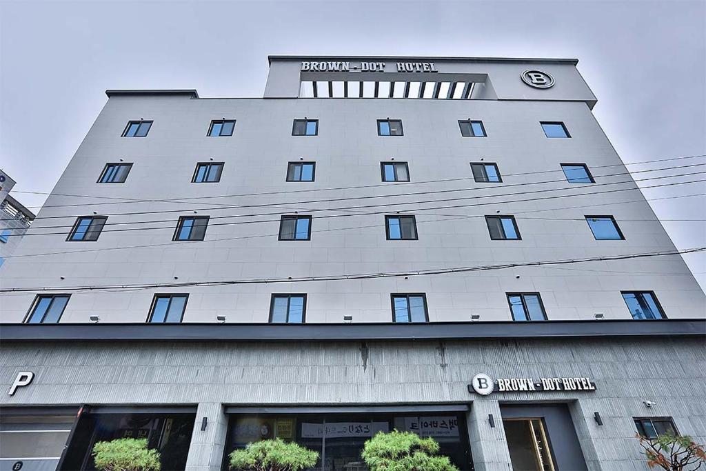 a large white building with a clock on it at Brown Dot Gumi Okgye in Gumi