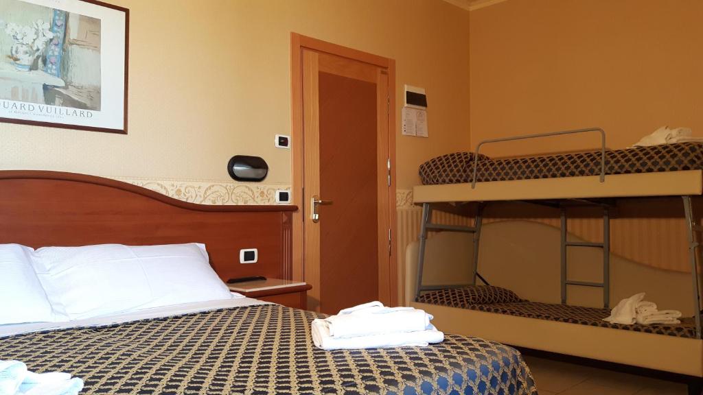 Postel nebo postele na pokoji v ubytování Hotel Grifone