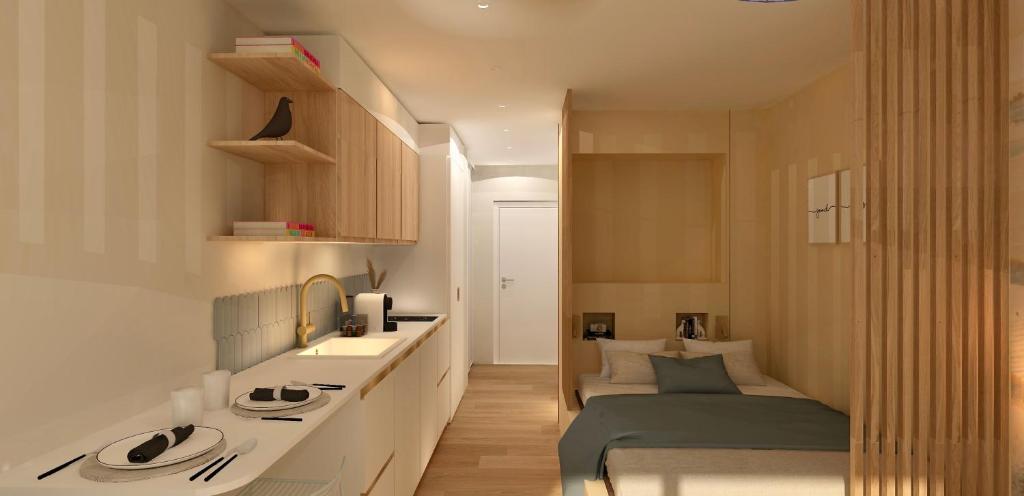 a bedroom with a bed and a sink in a room at Studio près de la plage in La Grande-Motte