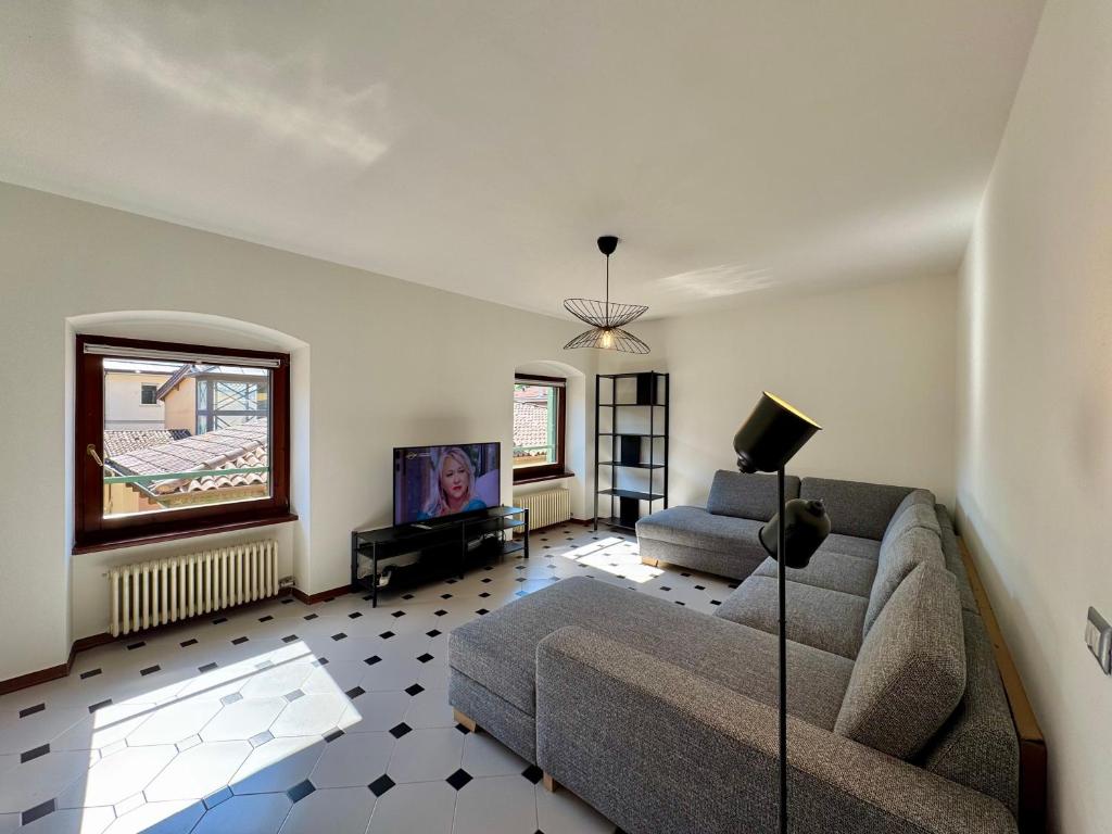 a living room with a couch and a tv at 1Dest - Riva Life in Riva del Garda