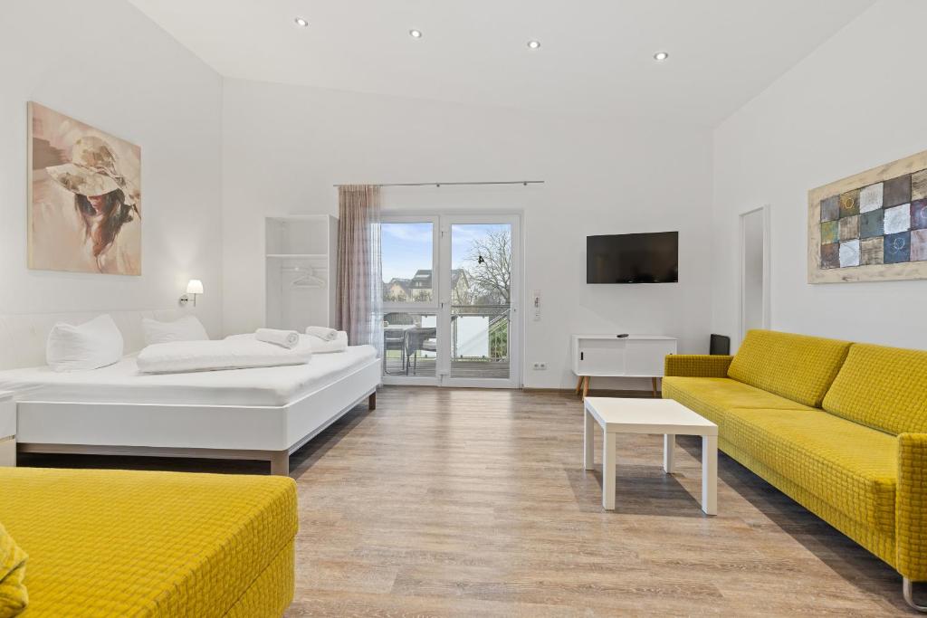 a living room with two couches and a tv at Apartments Münchbach - near Europa-Park and Rulantica in Rust