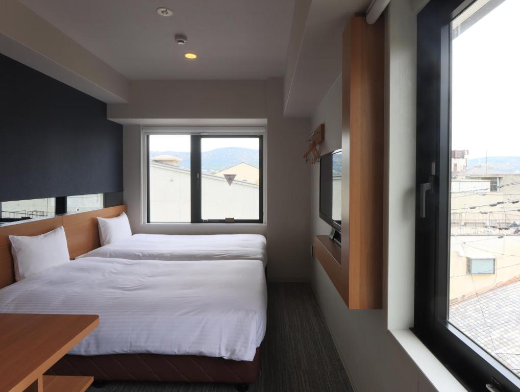 Postel nebo postele na pokoji v ubytování Hotel Glad One Kyoto Shichijo by M's