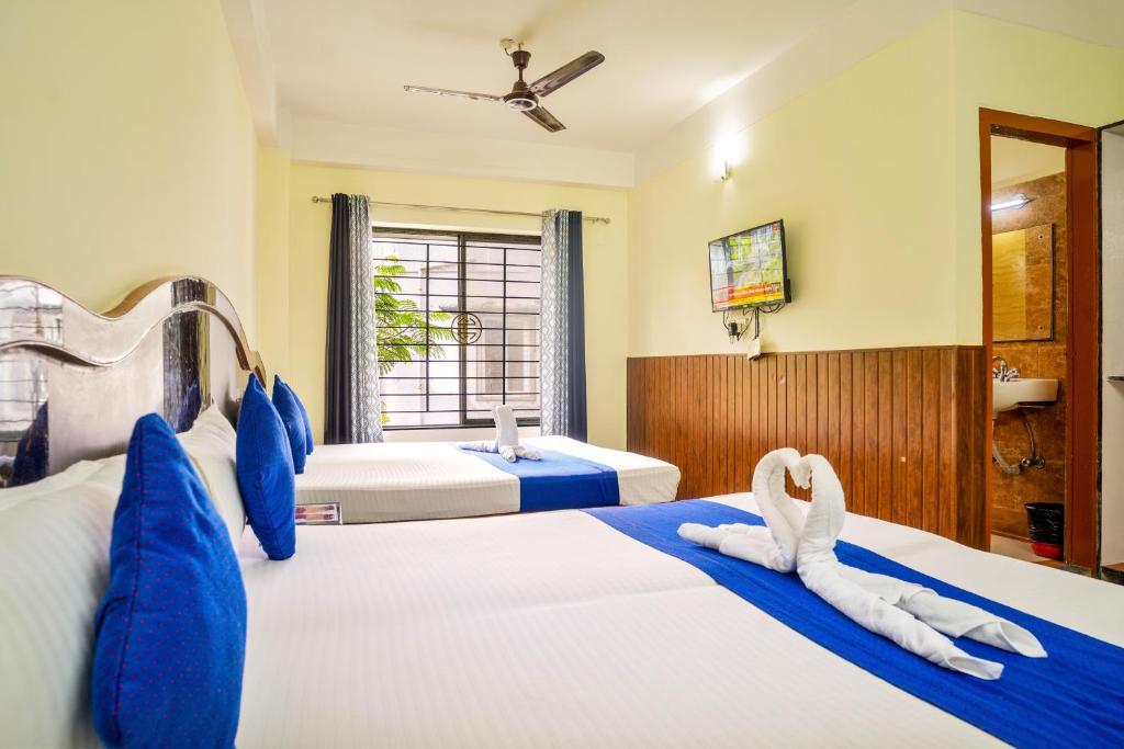 Postel nebo postele na pokoji v ubytování HOTEL NILADRII GALAXY